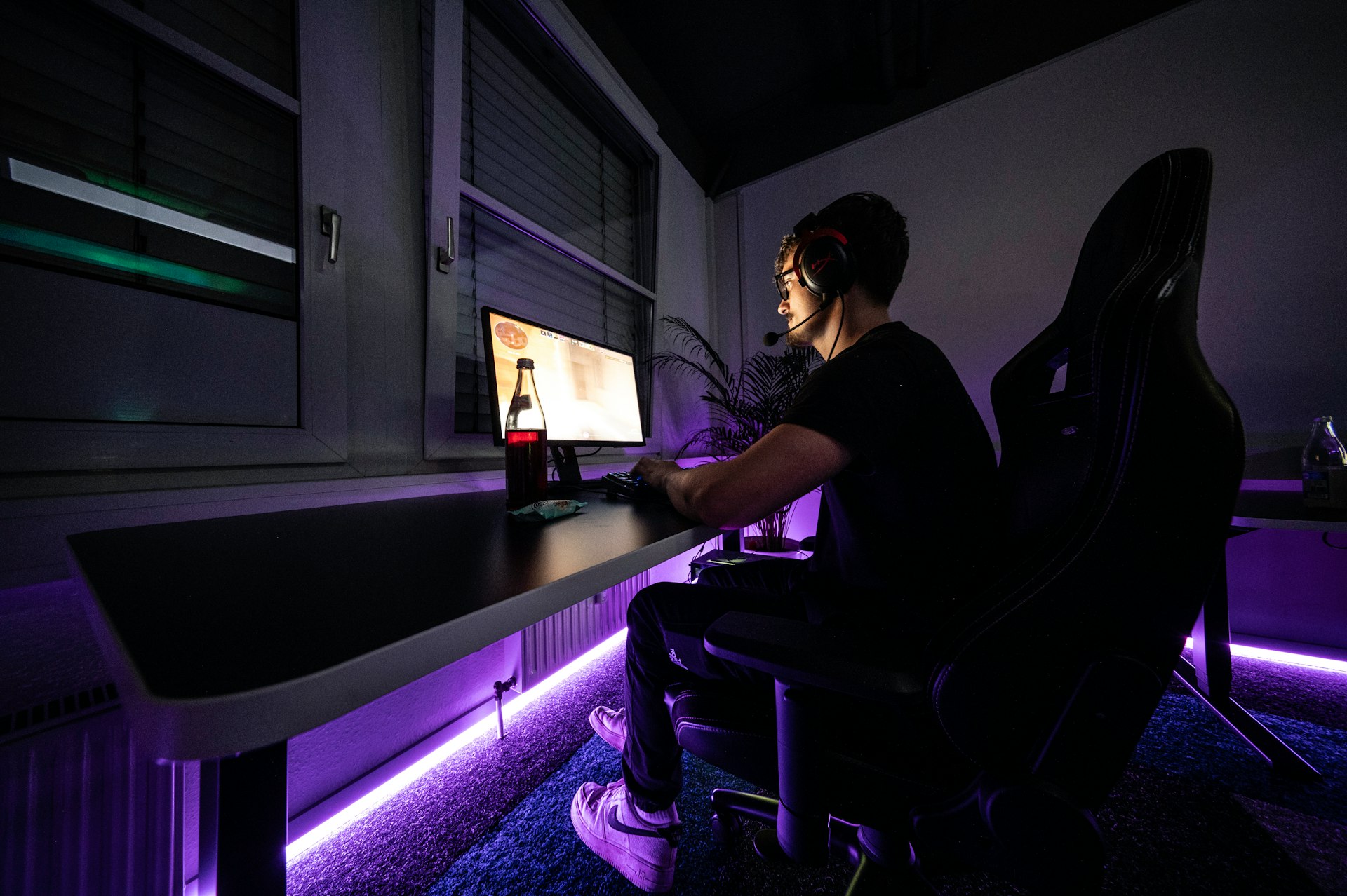 A man sitting at a desk with a computer in front of him